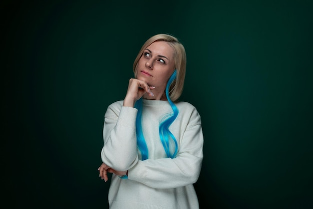 Woman in white sweater posing for picture