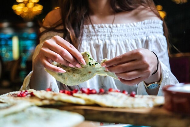 Photo woman in white top eating a tortilla