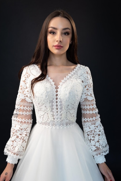 A woman in a white wedding dress with long sleeves and a long sleeved top