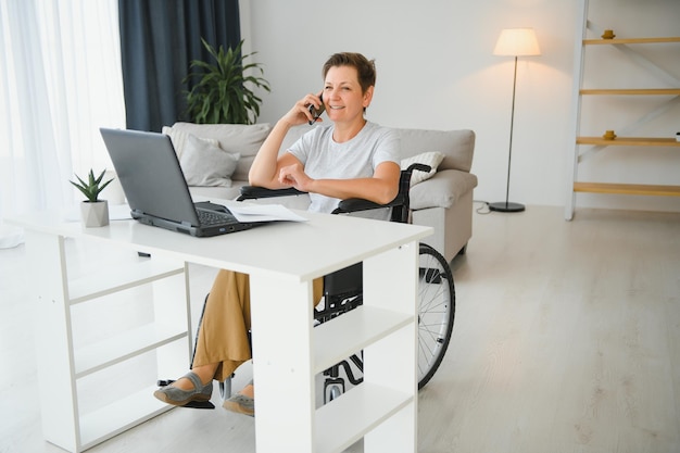 Woman who uses wheelchair working on computer