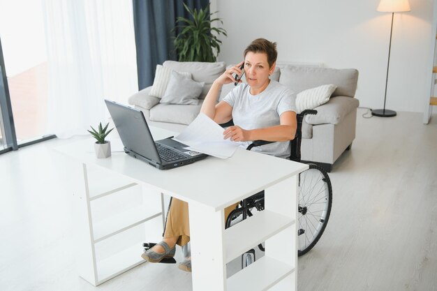 Woman who uses wheelchair working on computer