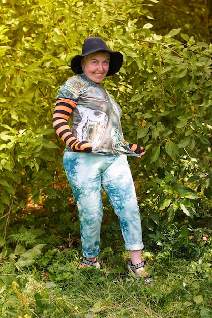 A woman in a witch hat for Halloween A cheerful dwarf in nature