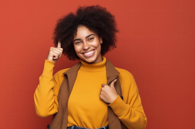 A woman with an afro pointing up with her finger up.