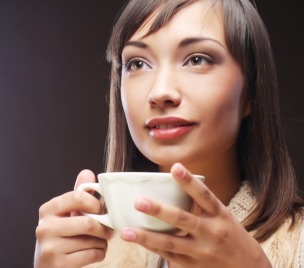 Woman with an aromatic coffee in hands