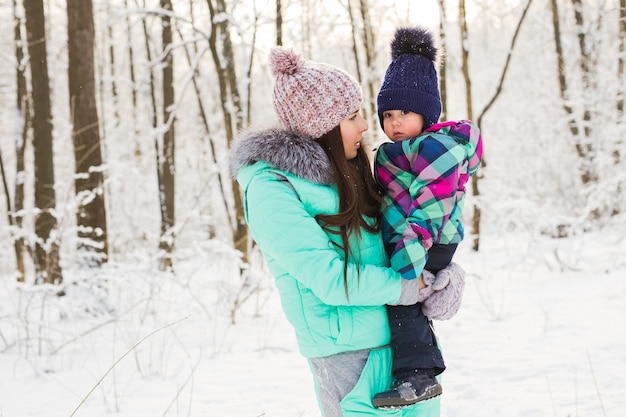 Woman with baby girl daughter in winter