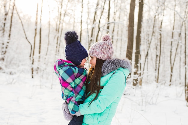 Woman with baby girl daughter in winter