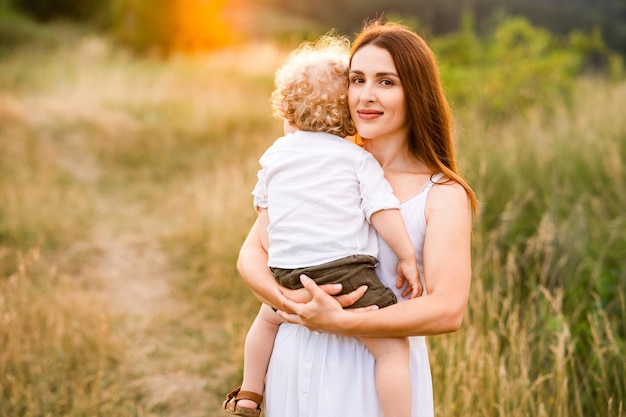 Woman with baby in her arms in nature