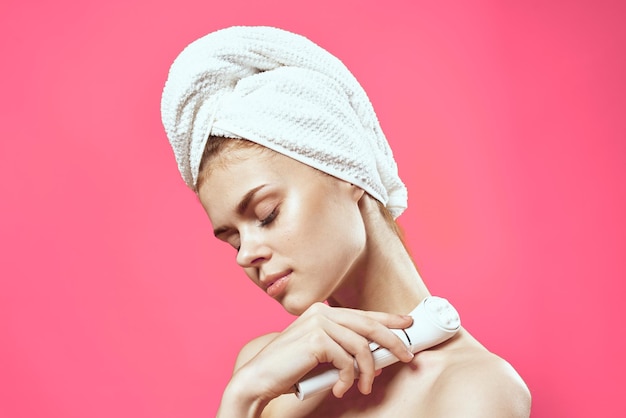 Woman with bare shoulders and skin cleaning cosmetology health pink background