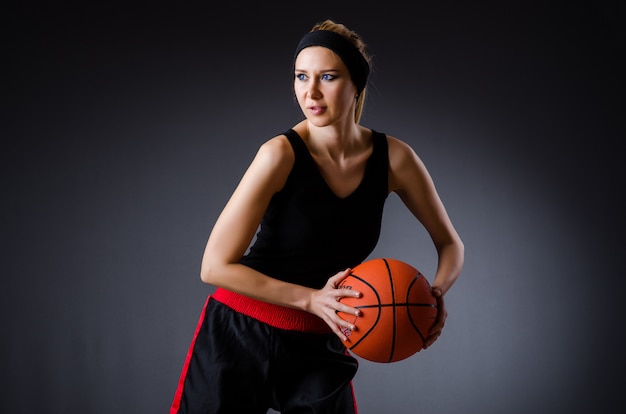 Woman with basketball in sport concept