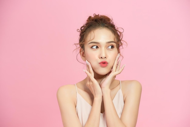 Woman with beautiful hairstyle over pink background