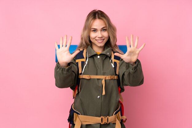 Woman with a big backpack in studio