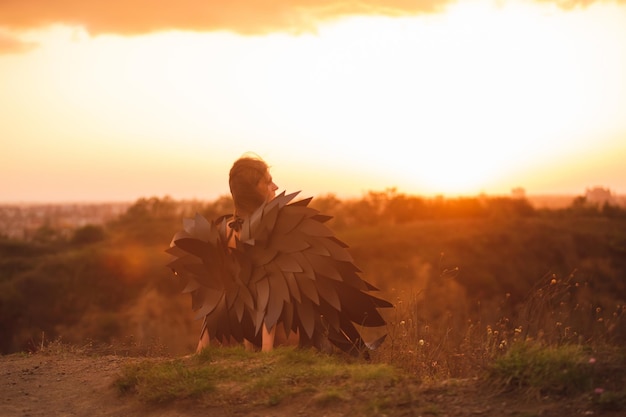 Woman with black angel wings at the hill