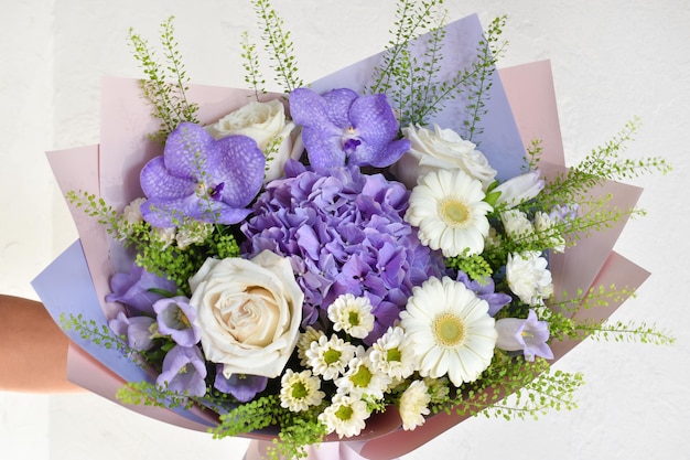 Woman with bouquet of flowers Beautiful flowers for holiday Woman with beautiful flowers in her hands indoors background bouquet of flowers for flower shop