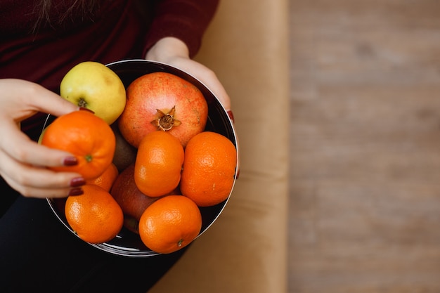 Woman with a bowl of fruits. Healthy lifestyle concept.