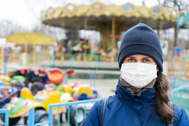 Woman with brown hair wearing face medical mask because of Air pollution