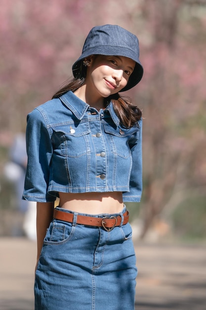 Woman with cherry blossoms or sakura flower blooming in the park