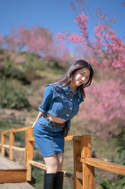 Woman with cherry blossoms or sakura flower blooming in the park