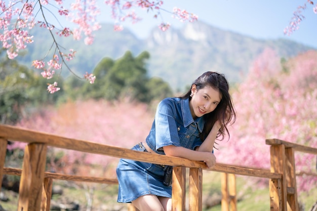 Woman with cherry blossoms or sakura flower blooming in the park