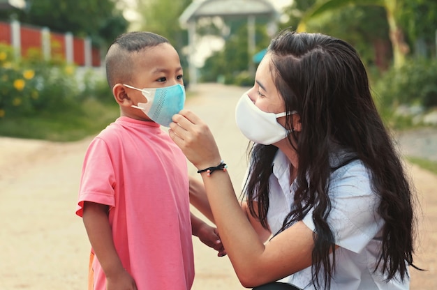 Woman with children wearing mask for protect virus corona covid19. healthcare concept