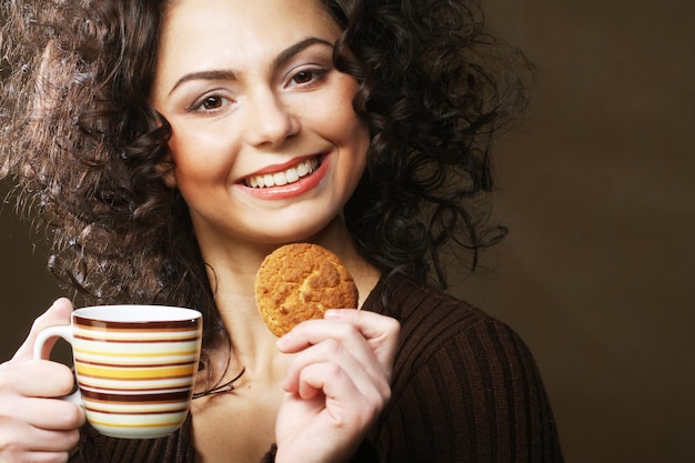 Woman with coffee and cookies