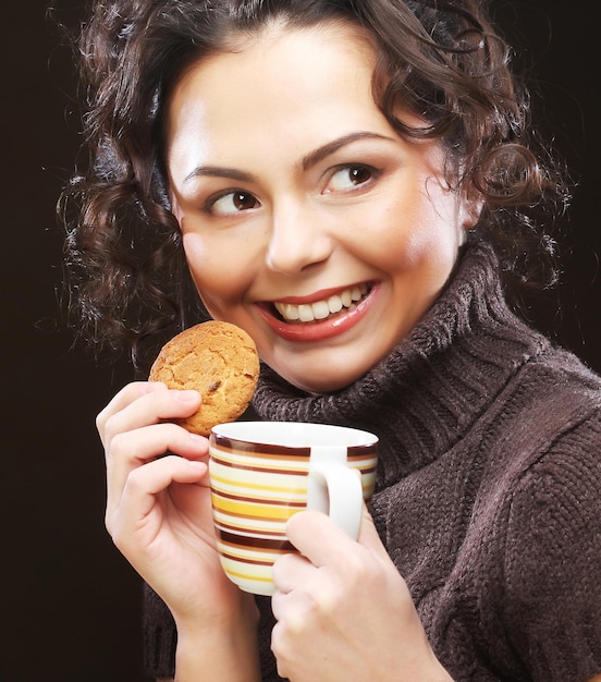 Woman with coffee and cookies