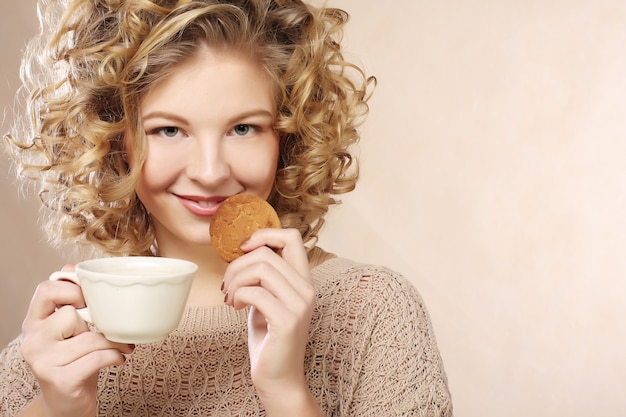 Woman with coffee and cookies