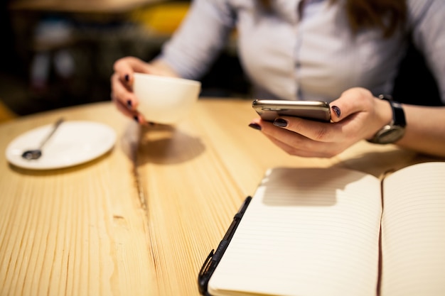 Woman with a coffee and a telephone