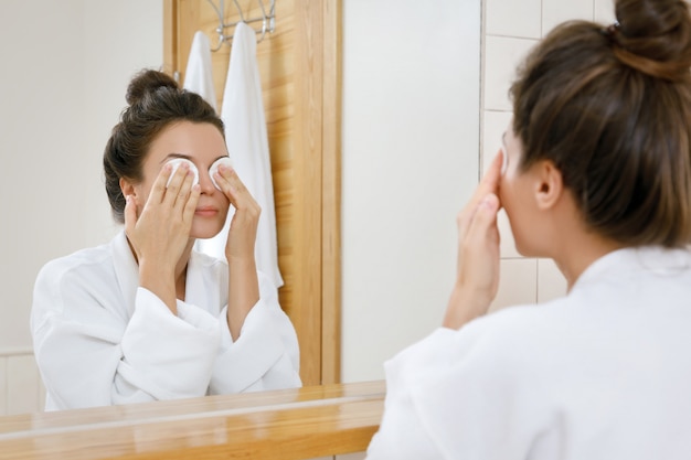 Woman with a cotton pads on her eyes