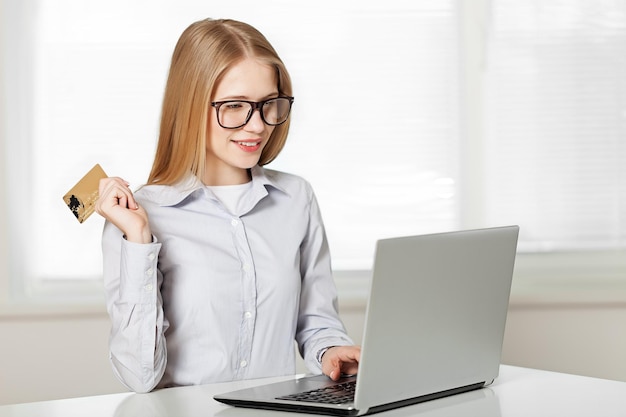 Woman with  credit card using laptop. Online shopping on the internet using a laptop,