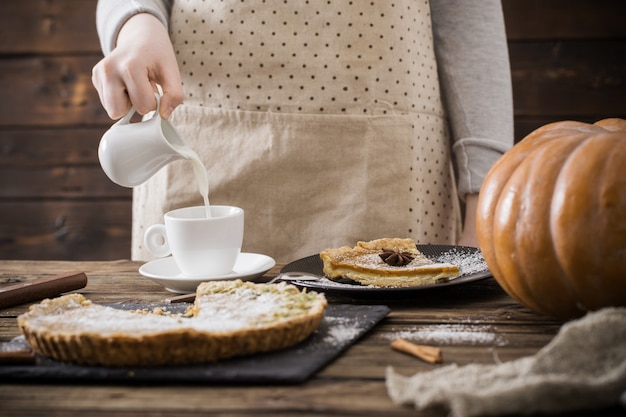 Woman with  cup of coffee and pumpkin pie