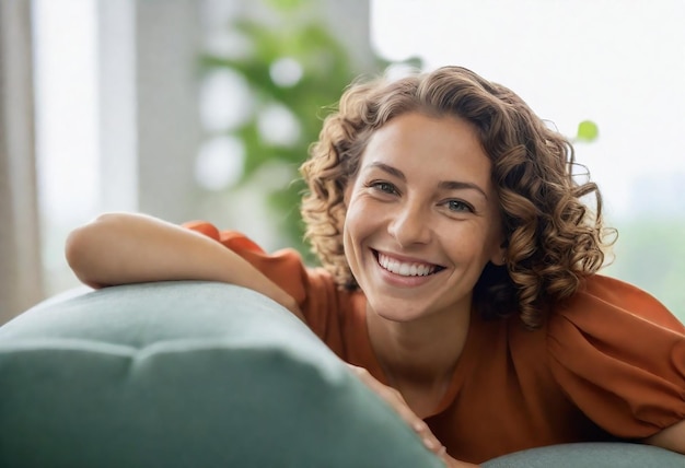 a woman with curly hair laying on a couch