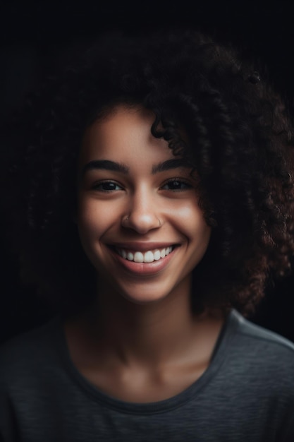 A woman with curly hair smiles at the camera.