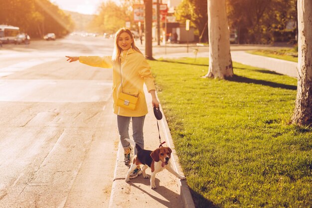 Woman with dog catching cab on roadside