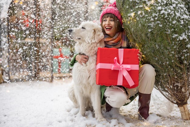 Photo woman with dog celebrates winter holidays