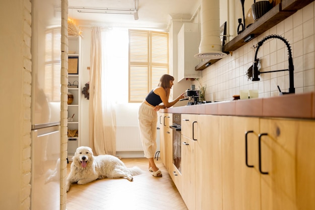 Woman with dog in modern and stylish kitchen