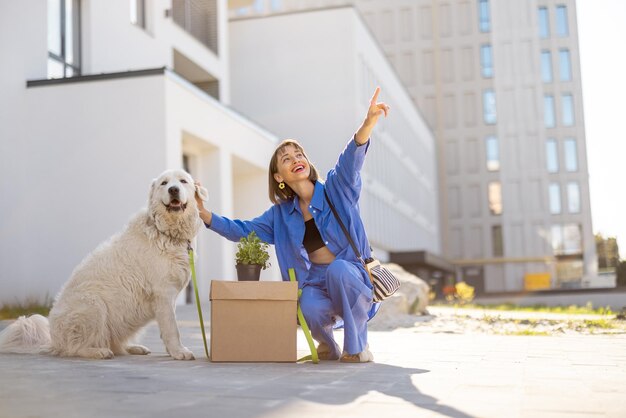 Woman with dog relocating to a new apartment