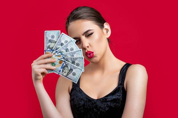 Woman with dollars in hand Portrait woman holding money banknotes Girl holding cash money in dollar banknotes Woman holding lots of money in dollar currency Luxury beauty and money concept