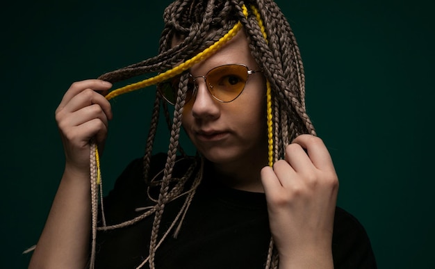 Woman with dreadlocks holding hair