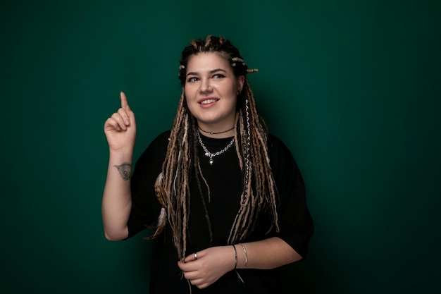 Woman with dreadlocks pointing at the camera