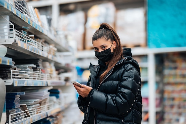 Woman with face mask buying during virus pandemic