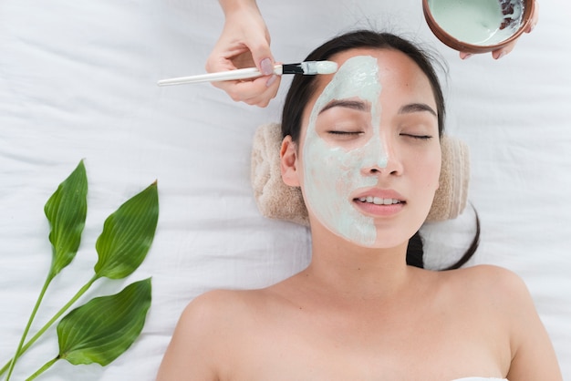 Woman with a facial mask in a spa