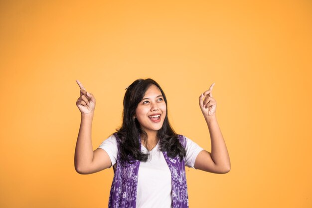 Woman with finger pointing up hand gesture on isolated background