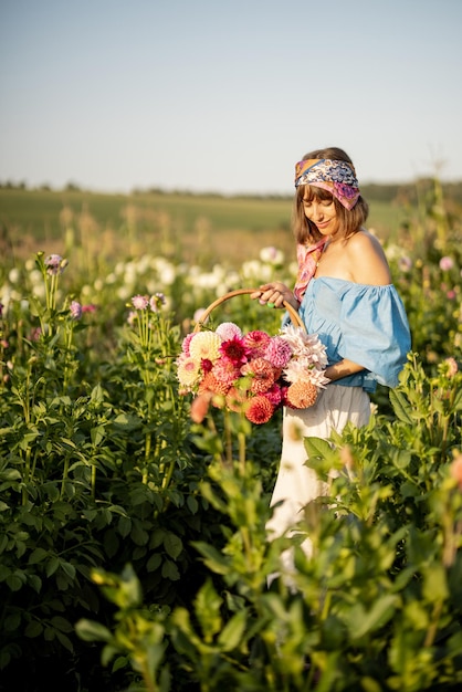 Woman with flowers on dahlia farm outdoors