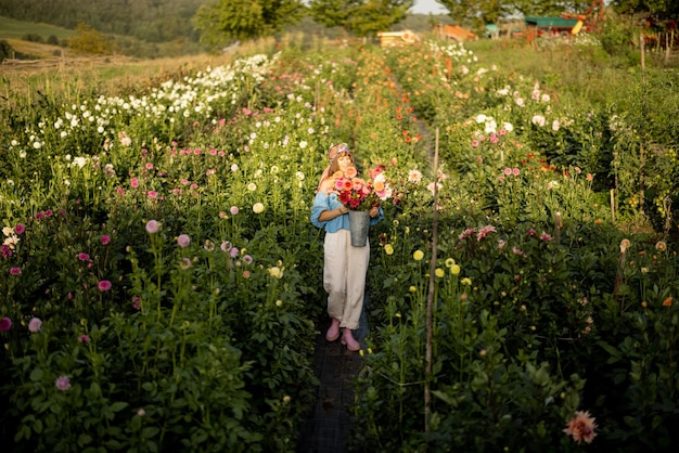 Woman with flowers on dahlia farm outdoors