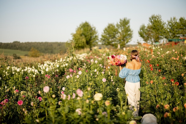 Woman with flowers on dahlia farm outdoors