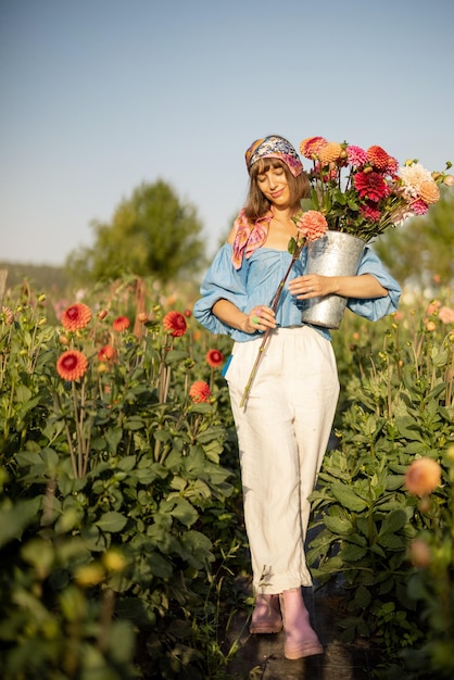 Woman with flowers on dahlia farm outdoors