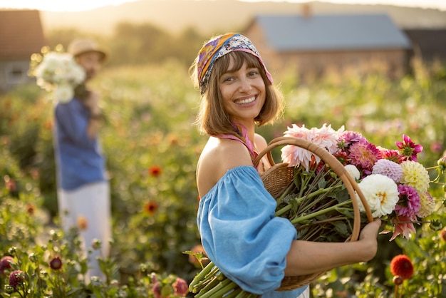 Woman with flowers on dahlia farm outdoors