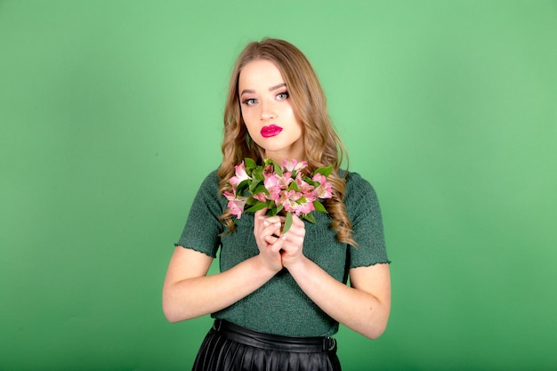 Woman with flowers on green background