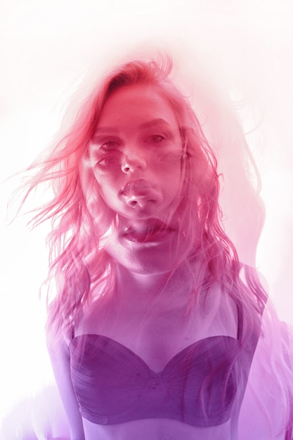 Woman with flowers inside, double exposure. Blonde girl in lingerie on crimson background, dreamy mysterious look. Wildflowers on a background of women with a double exposure on a light background