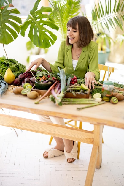 Woman with fresh healthy food ingredients indoors